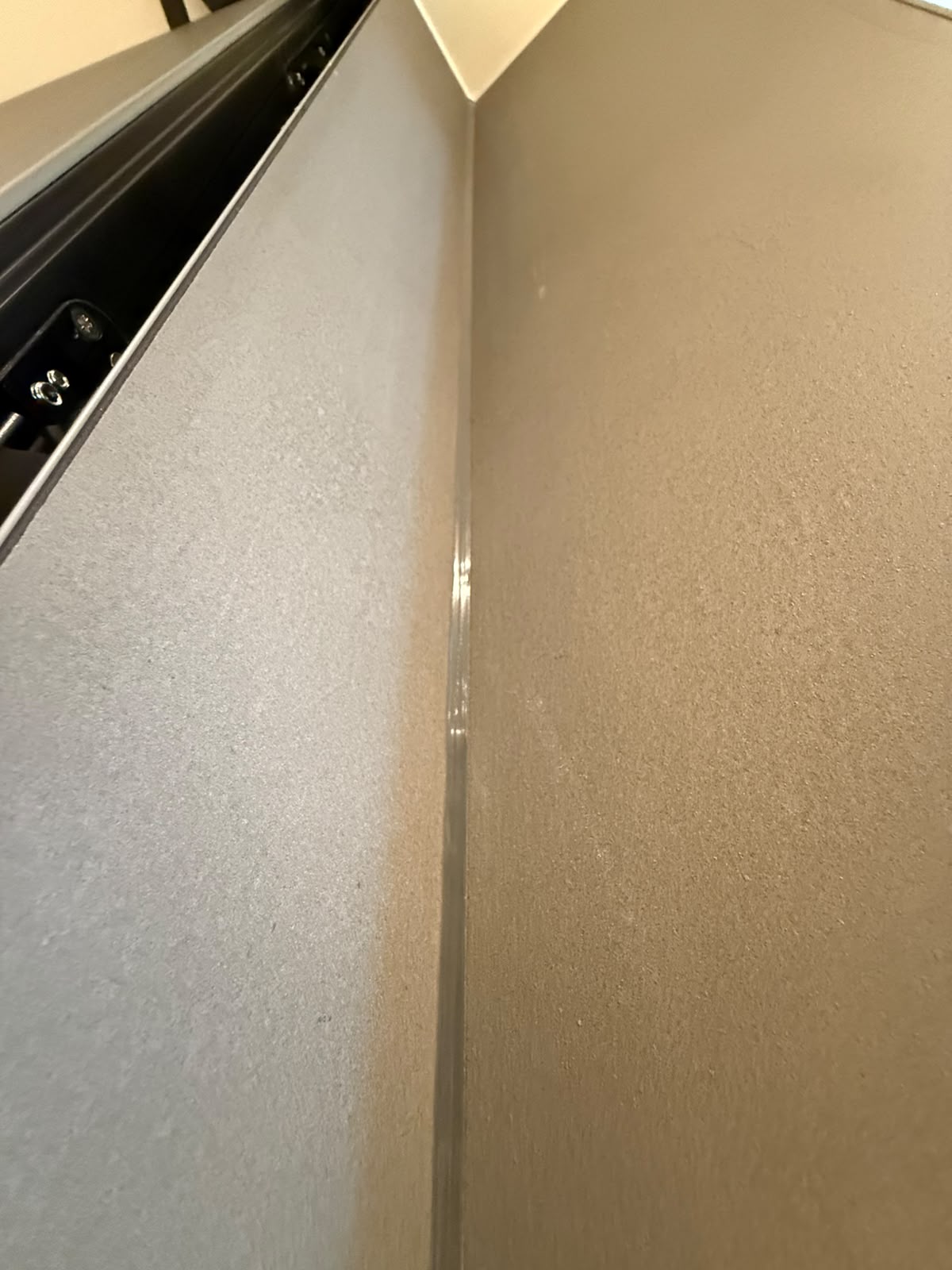 Interior wall junction sealed with a fine clear bead by Blackline Mastic