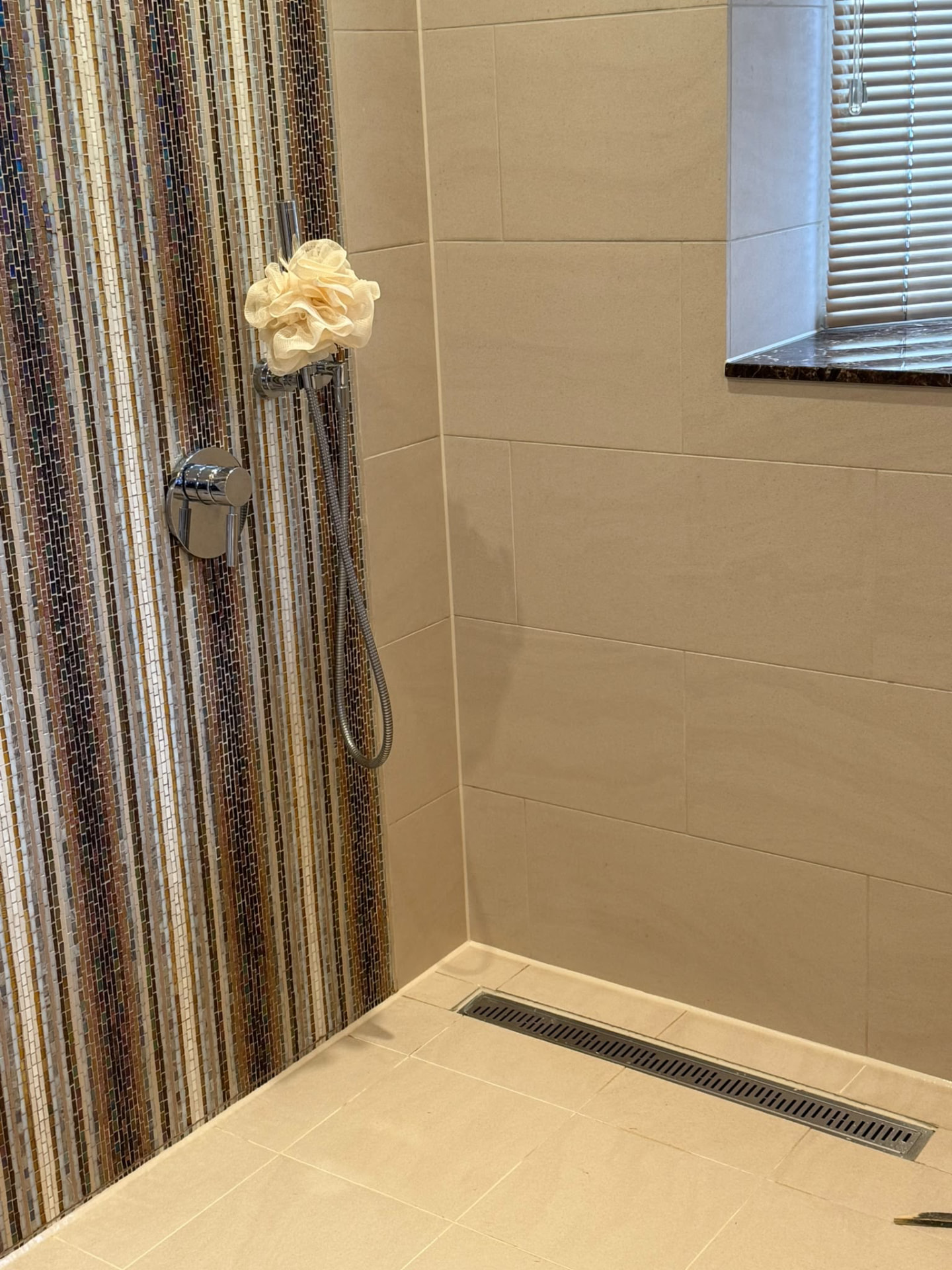 Wetroom floor and mosaic wall perimeter sealed by Blackline Mastic
