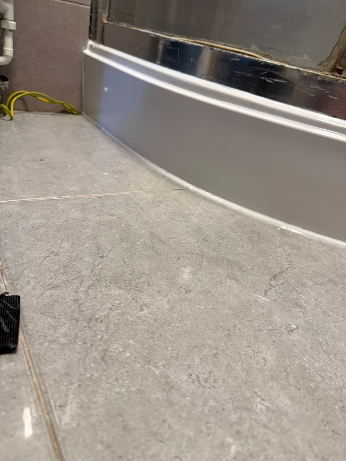 Curved shower tray resealed with fresh silicone by Blackline Mastic