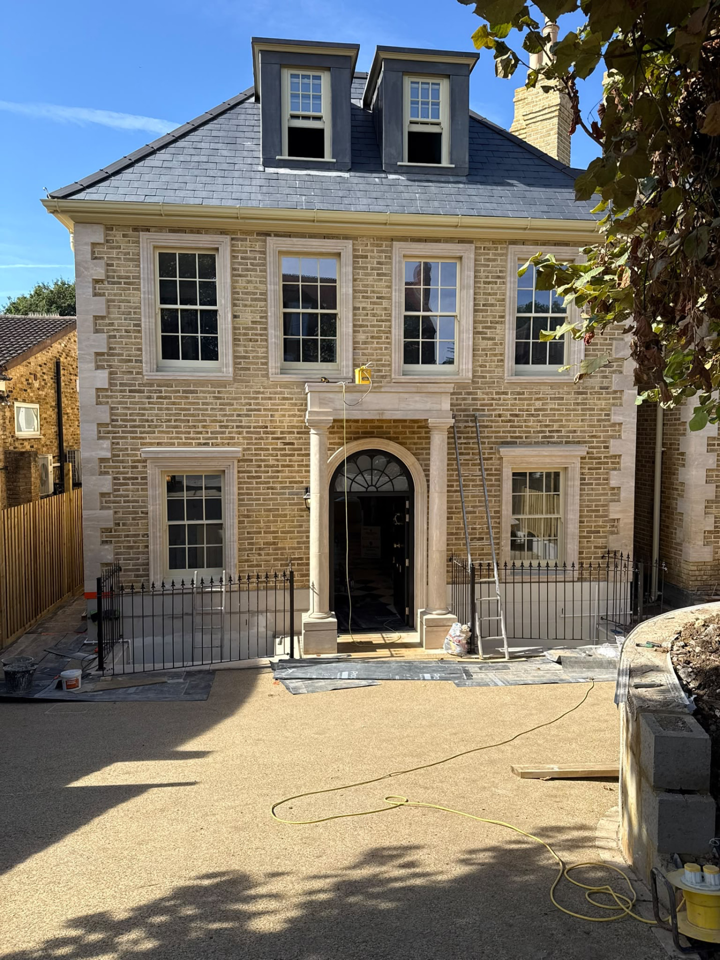 Property exterior with newly installed windows and doors sealed by Blackline Mastic