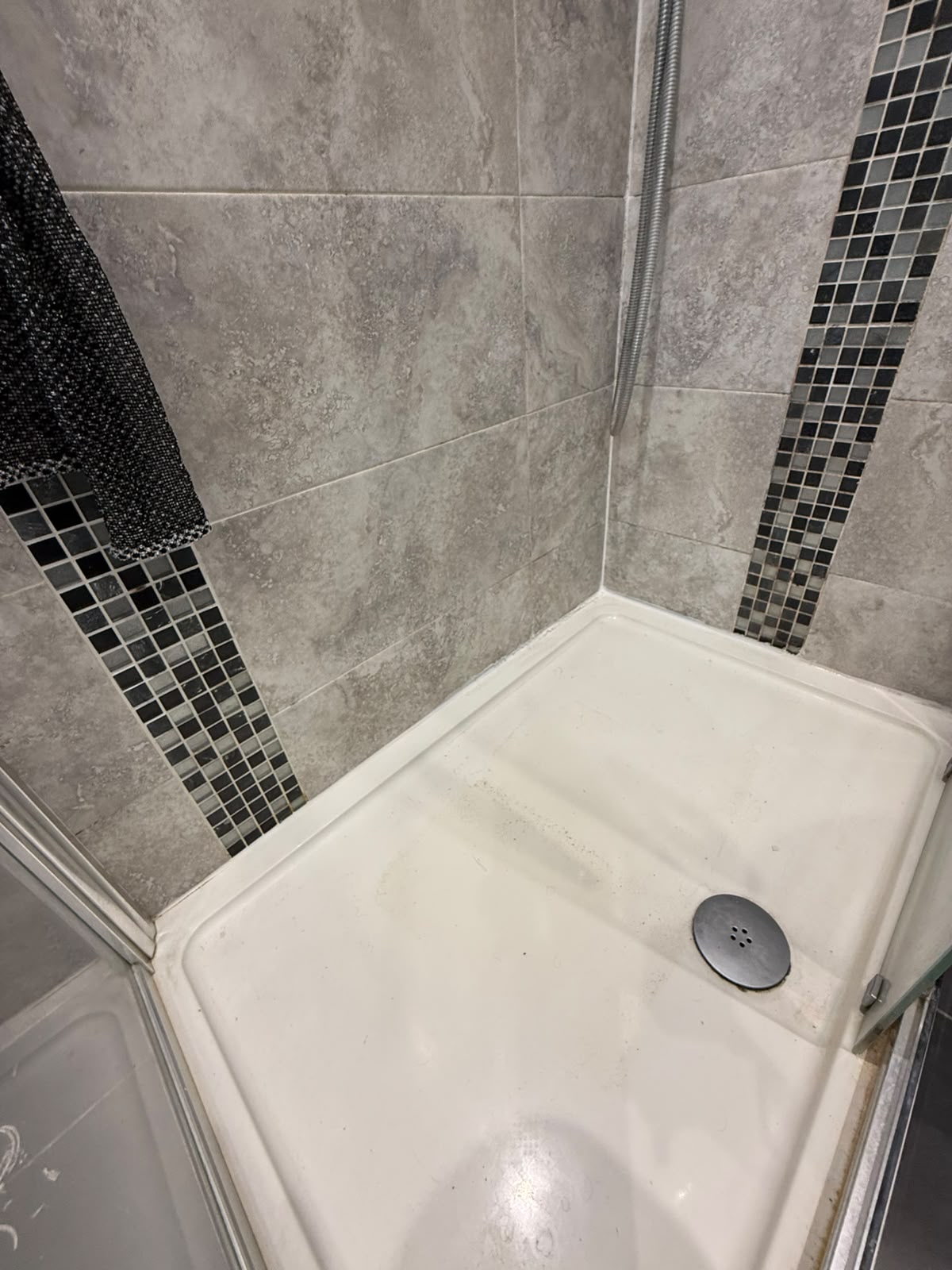 Shower tray and mosaic tiling sealed by Blackline Mastic