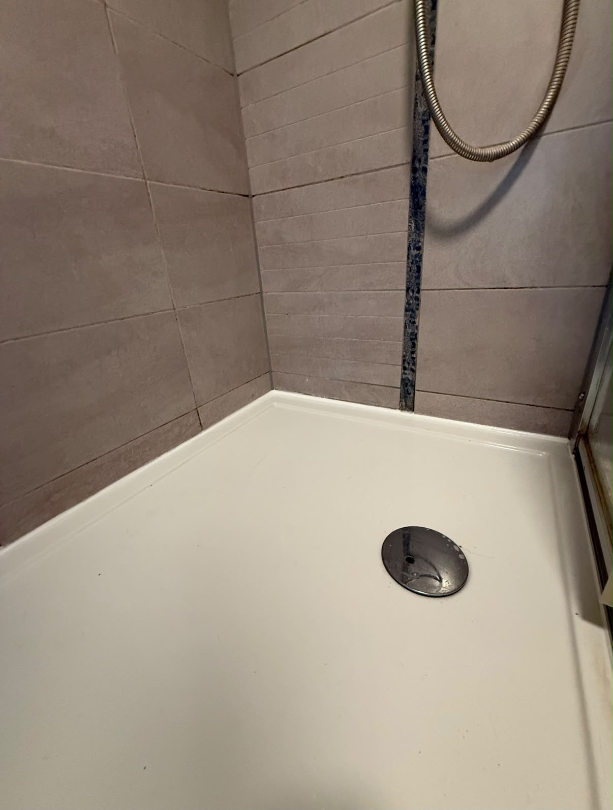 Shower tray perimeter joint sealed by Blackline Mastic